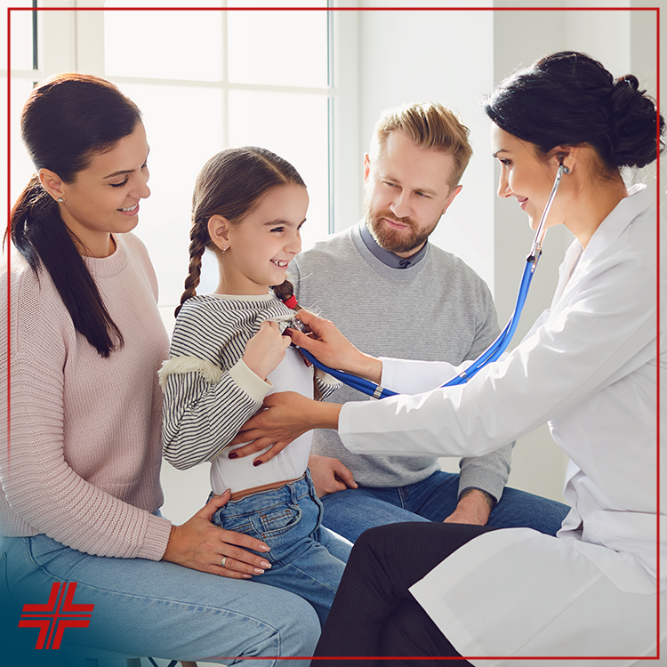 A doctor uses a stethoscope to examine a smiling young girl, while her parents sit beside her, all looking happy and relaxed in a bright, modern medical office. | California Urgent Care Center